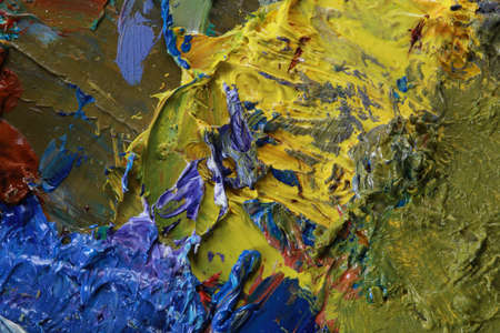 macro artist's palette, texture mixed oil paints in different colors and saturation studioの写真素材