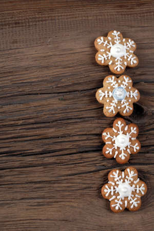 close-up still-life of Cookies in the shape of snowflakes, hearts and stars on magic Christmas holiday on background wooden boards studioの写真素材