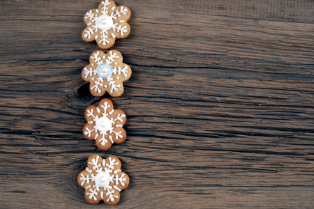 close-up still-life of Cookies in the shape of snowflakes, hearts and stars on magic Christmas holiday on background wooden boards studioの写真素材