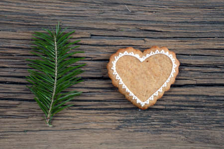 close-up of beautiful festive Christmas still life of the branches of spruce, cookies and spice on wood background with cracks studioの写真素材