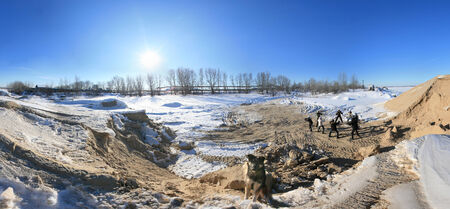 winter landscape trees in frost and snow drifts on the river on a bright sunny dayの写真素材