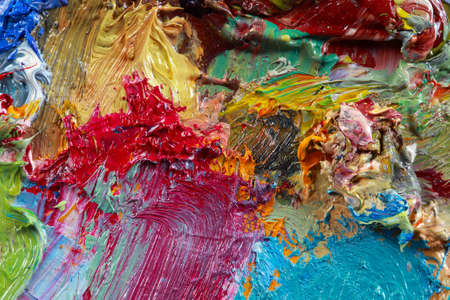 macro artist's palette, texture mixed oil paints in different colors and saturation studioの写真素材