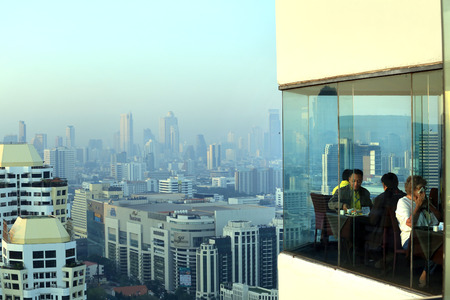 BANGKOK, THAILAND - December 15, 2015: beautiful foggy sunset over Bangkok, view from skyscraper December 15, 2015 in Bangkok, Thailand.のeditorial素材