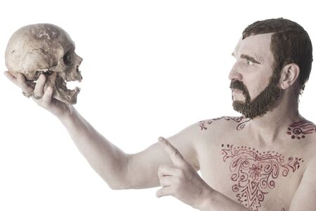 close-up portrait of an adult male with a naked torso and body painting with henna and colored hair and beard studioの写真素材