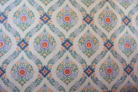 close-up texture fragment of a wall of a Buddhist temple  hand painted floral ornament