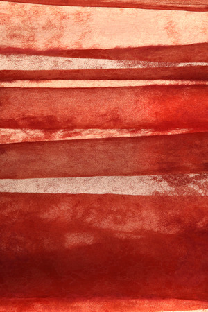 macro translucent red fabric with an openwork patternの写真素材