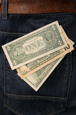 close-up of dollar bills pocket denim trousers, studioの写真素材