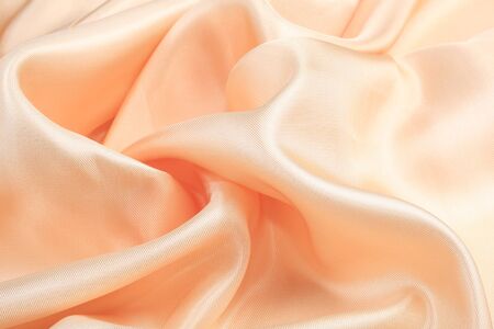 macro texture of satin fabric peach color studioの写真素材