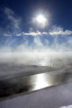 winter landscape pairs of freezing river on a sunny dayの写真素材