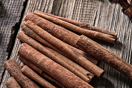 close-up isolated cinnamon sticks on a background of the old board studio