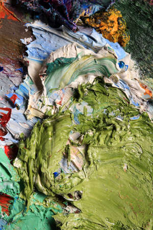 macro artist's palette, texture mixed oil paints in different colors and saturation studioの写真素材