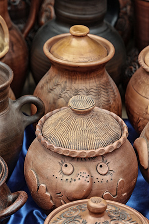 macro several types of clay pottery pots, pitchers, teapots at the fair in the summerの写真素材
