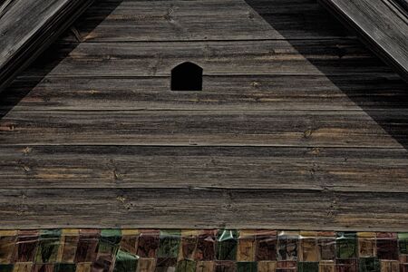 macro texture wall fragment of the old wooden house in the sunlightの写真素材