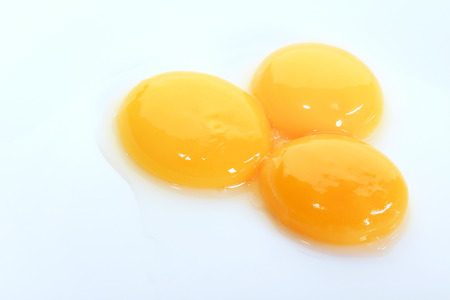macro egg yolks on a white plate studioの写真素材