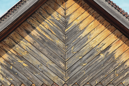 macro texture wall fragment of the old wooden house in the sunlightの写真素材