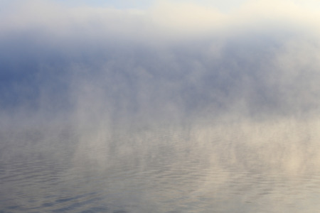 winter landscape dense fog over the river early in the morning at sunriseの写真素材