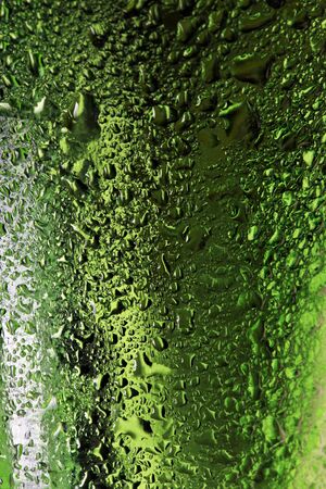 macro texture water drops on green glass studioの写真素材