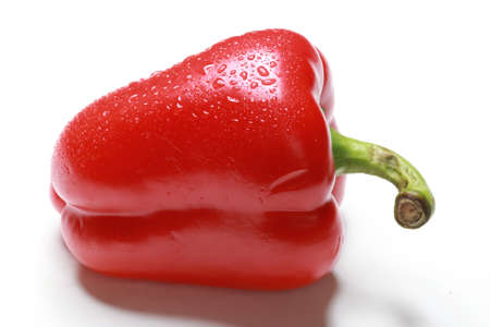 macro one red bell pepper in drops of dew on a white background studio