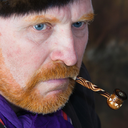 close-up portrait of the adult artist with red beard and mustache in the style of Vincent van Gogh studio on dark backgroundの写真素材