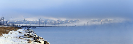 winter landscape dense fog over the river early in the morning at sunriseの写真素材
