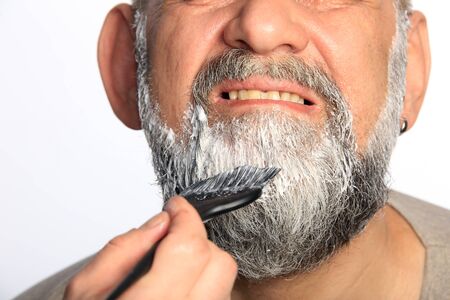 close-up portrait of an adult male color beard and mustache on white background studioの写真素材