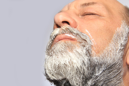 close-up portrait of an adult male color beard and mustache on white background studioの写真素材