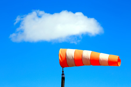 close-up of orange windsock on blue sky backgroundの写真素材