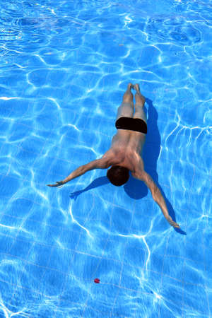 isolated azure water pool and swimmer in the water