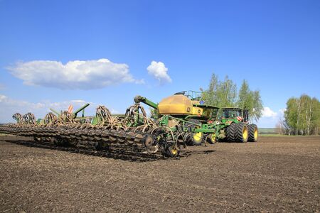 Naberezhnye Chelny, Russia - May 12, 2015: Planting in the field with the help of modern technology on a sunny spring day in May 2015のeditorial素材