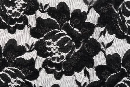 macro texture with black guipure flowers on a white backgroundの写真素材