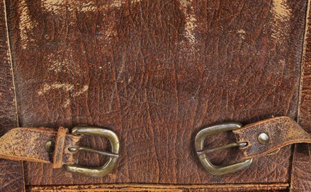 close-up fragment of locks and fasteners on the vintage leather suitcase brownの写真素材
