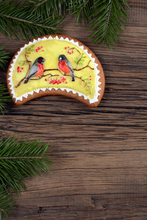 close-up still-life of fir branches and the gingerbread with pattern on magic Christmas holiday on background a wooden boards studioの写真素材