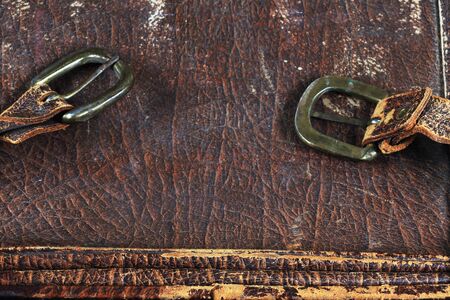 close-up fragment of locks and fasteners on the vintage leather suitcase brown