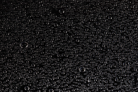 close-up texture water droplets on glass on gray background
