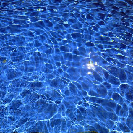 isolation Azure water outdoor swimming pool with reflections of sunlight