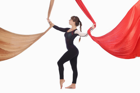 girl gymnast on aerial silk isolated on white background studioの写真素材
