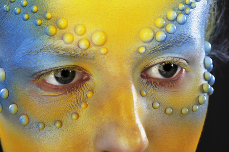 close-up of body art - the girl chameleon on a dark background Studioの写真素材