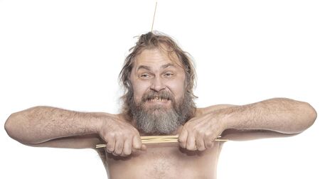 close-up portrait of a cheerful man with a sticks in beard studioの写真素材
