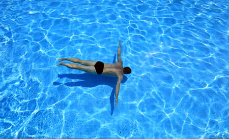 isolated azure water pool and swimmer in the waterの写真素材