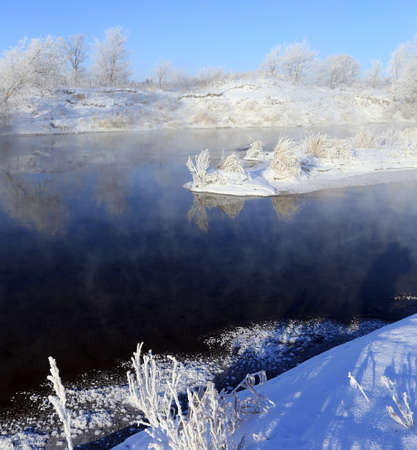foggy winter landscape frosty morning over the river and trees in hoarfrost on the shores ofの写真素材