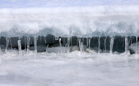macro isolated texture of ice and icicles on the river in early spring in the sunlight