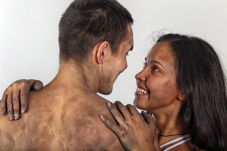 close-up portrait of young boy and girl drawing on white paper kinetic drawingsの写真素材