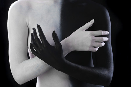 portrait nude of a slim young woman with painted body, body art in black and whiteの写真素材