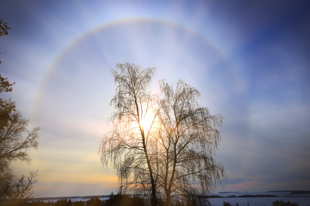 winter landscape snow-covered fields, trees and roads in sunlight raysの写真素材