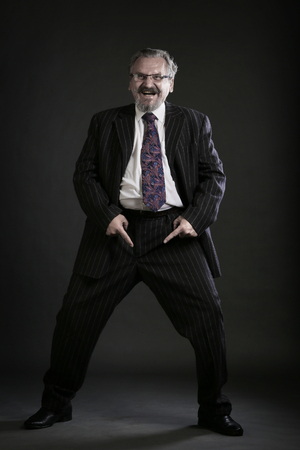 closeup portrait of an adult male with a mustache and beard, wearing glasses and a business suit studioの写真素材