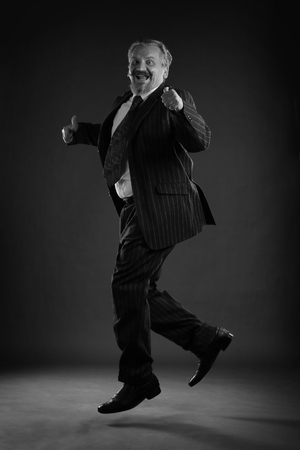 closeup portrait of an adult male with a mustache and beard, wearing glasses and a business suit studioの写真素材