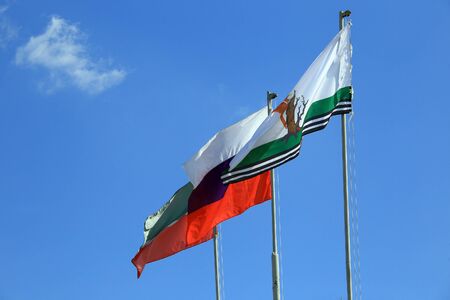 close-up of various flags on a blue sky background the skyの写真素材