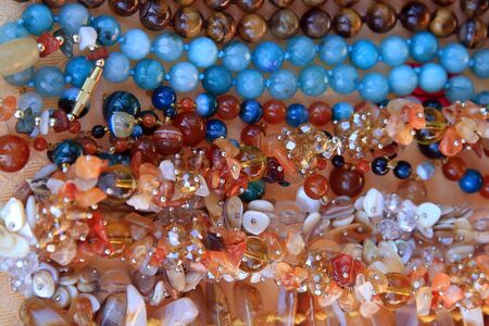 macro texture background colored beads of different shapesの写真素材