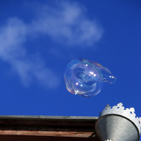 macro background weightless clouds, bubbles and downpipe on a blue sky on a sunny dayの写真素材