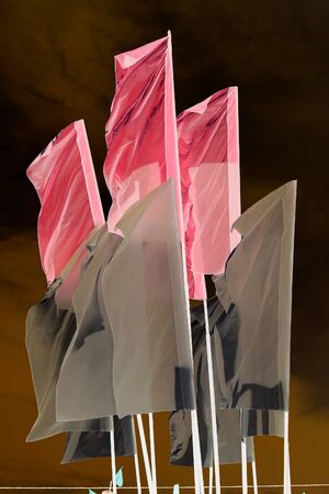 close-up of various flags on a blue sky background the skyの写真素材